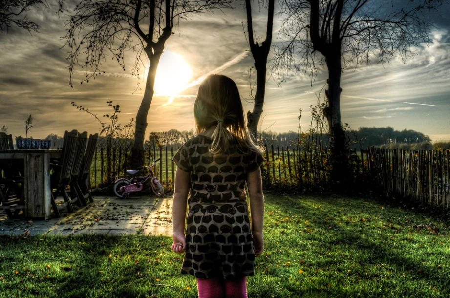 a little girl standing in the garden